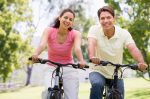 Couple riding bikes in countryside